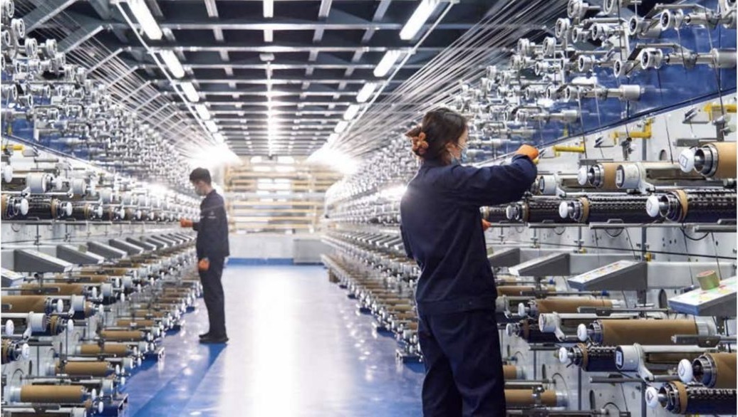 Technicians working on the fibre production line